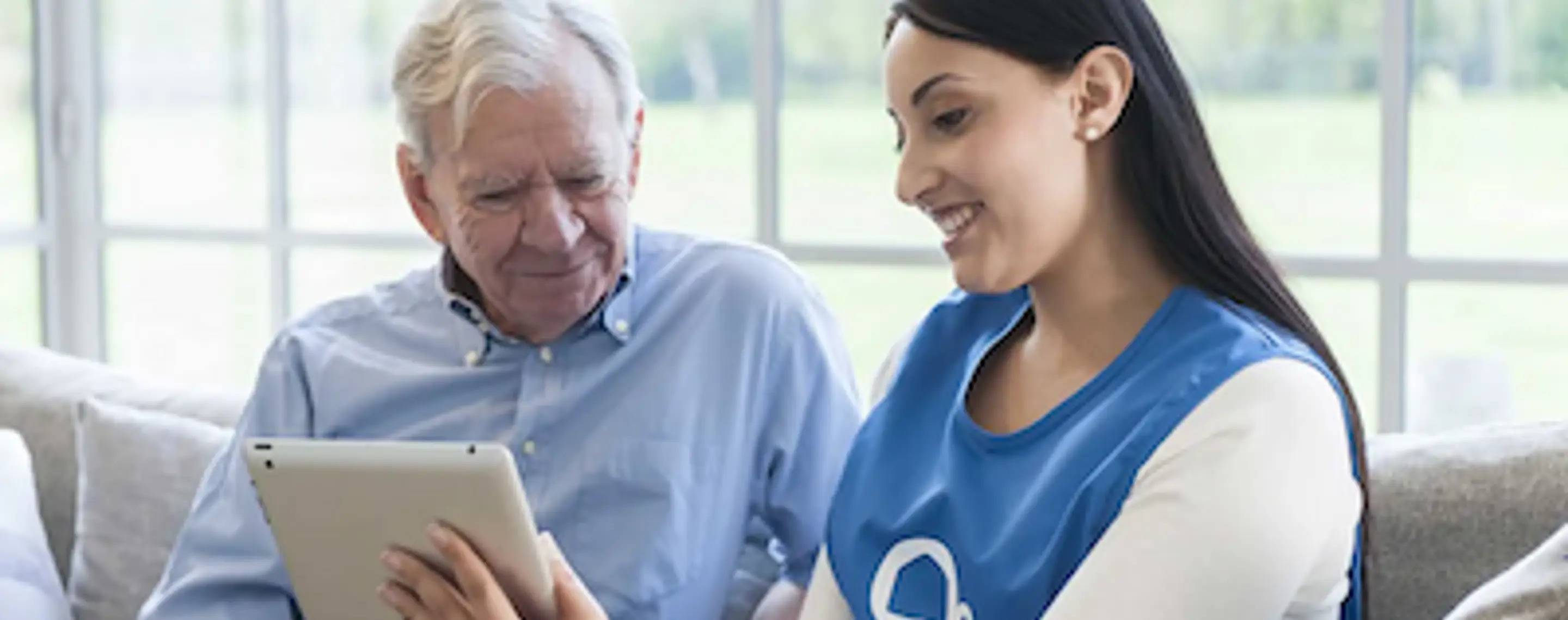 Two people looking at a tablet device