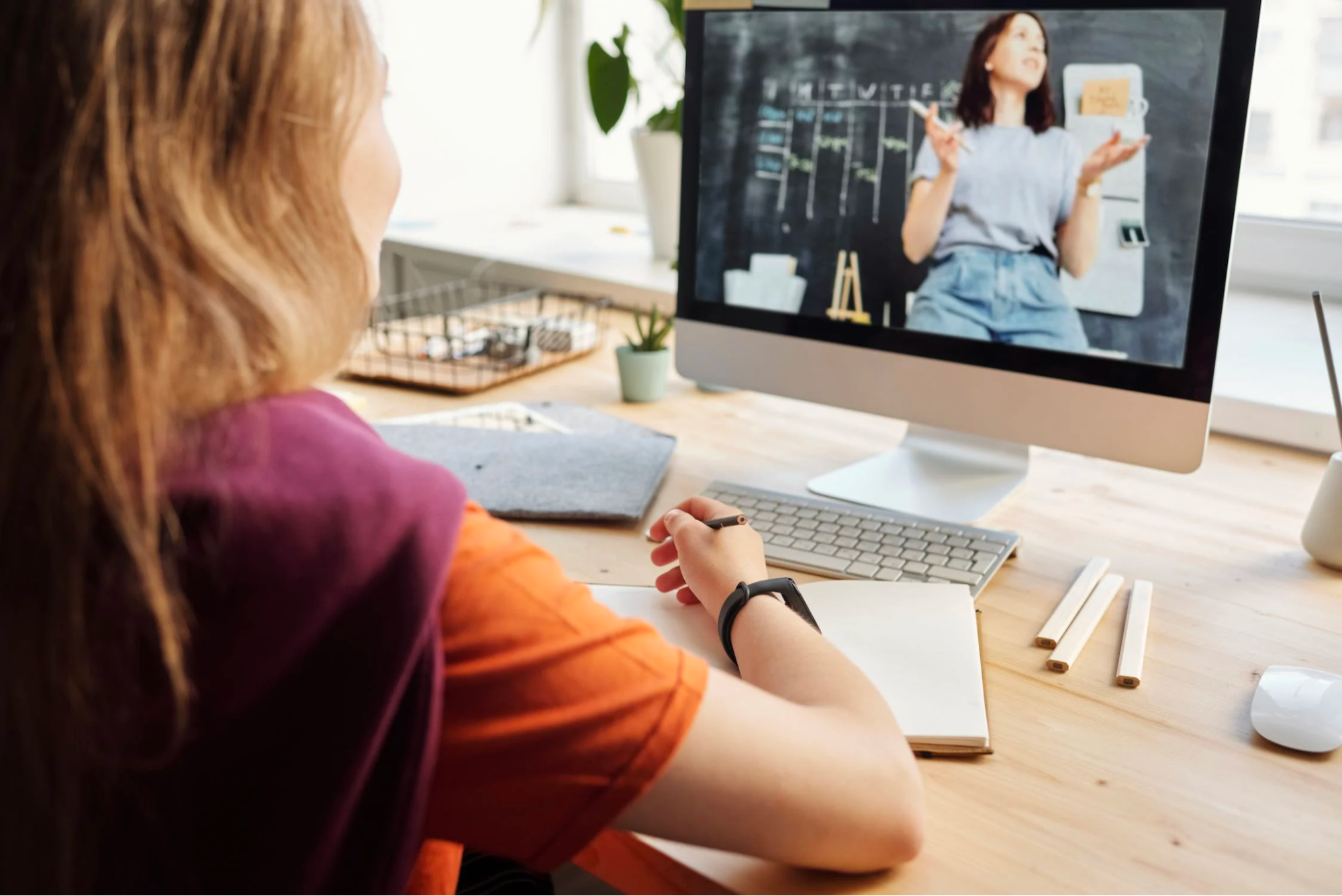 female employee watches educational learning video at work